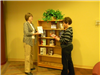 Two women looking at a bookshelf