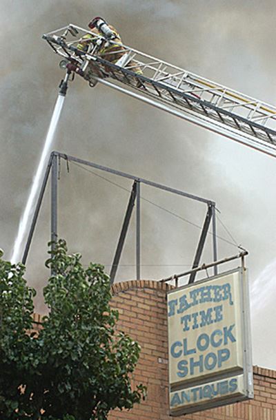 Fire in a brick building being sprayed with water
