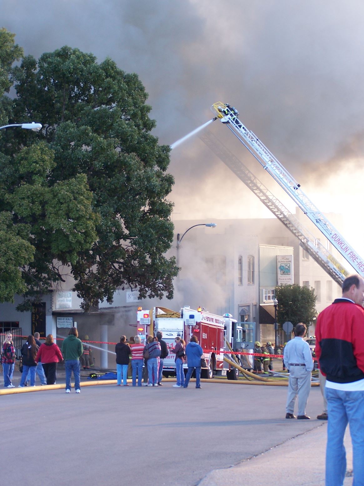 People watching the fire fighter contain the fire