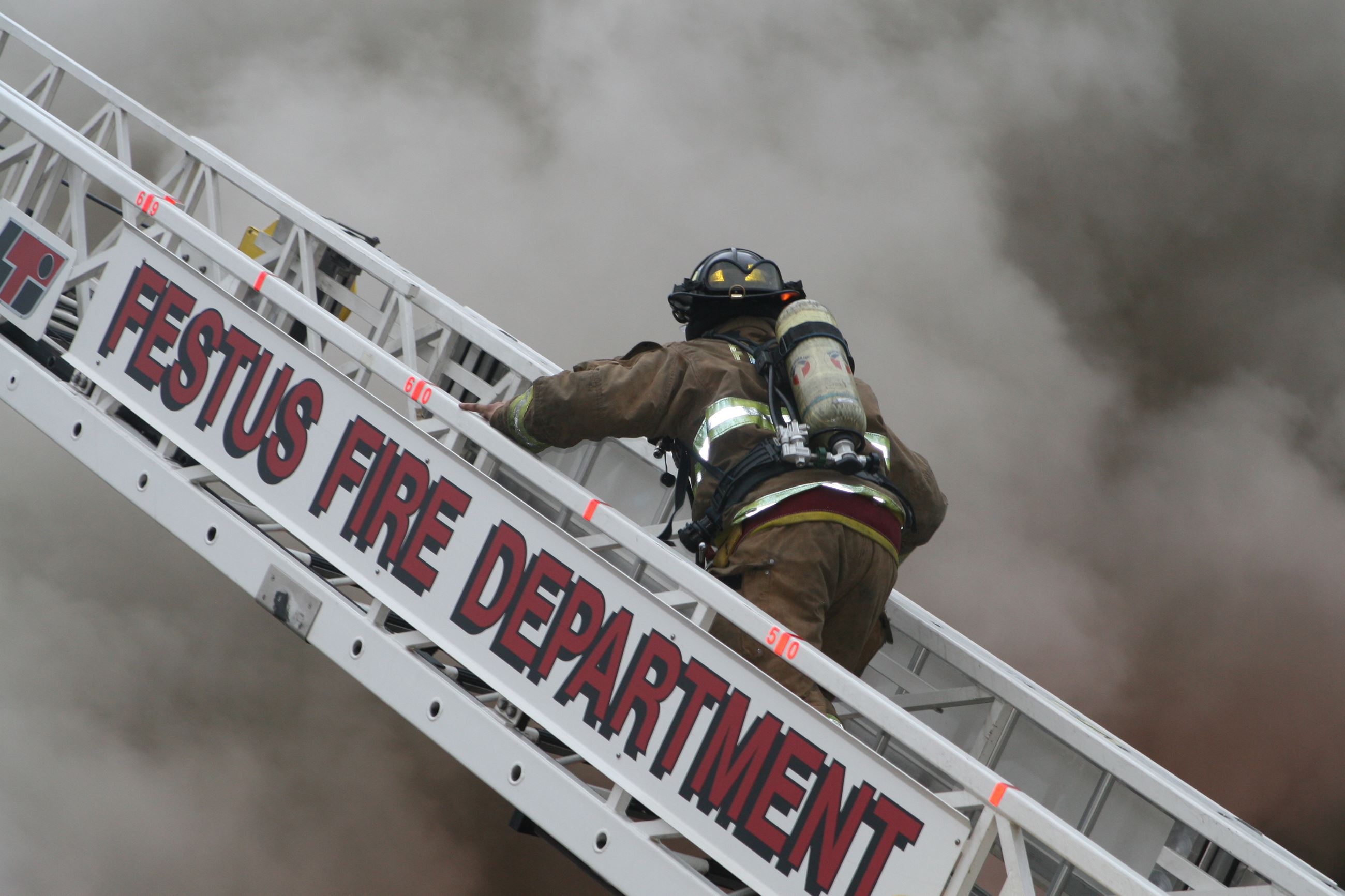 Fire fighter climbing the ladder
