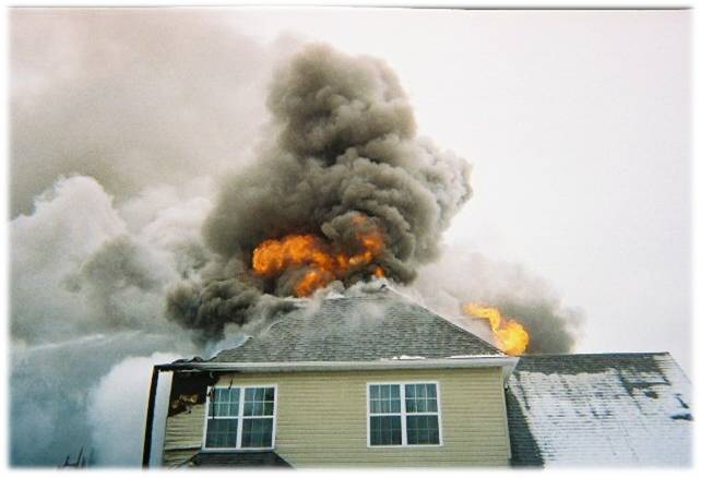 House with fire coming out of the roof