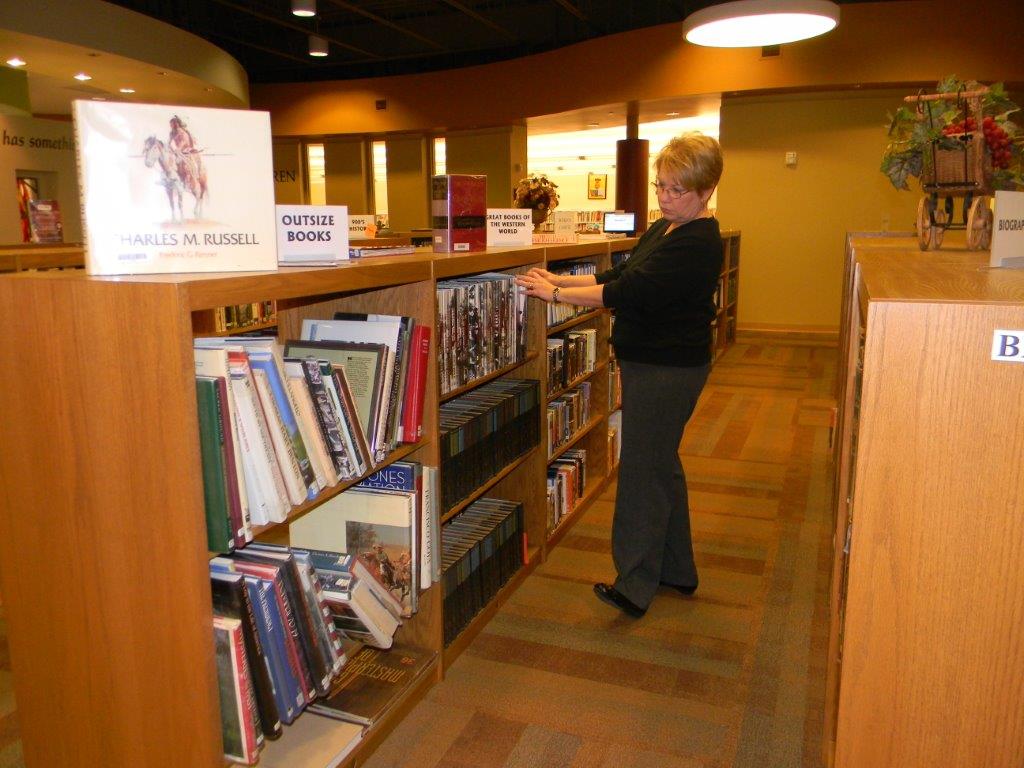 Woman looking through bookshelves