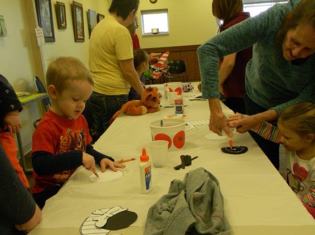 Adults and children doing crafts together
